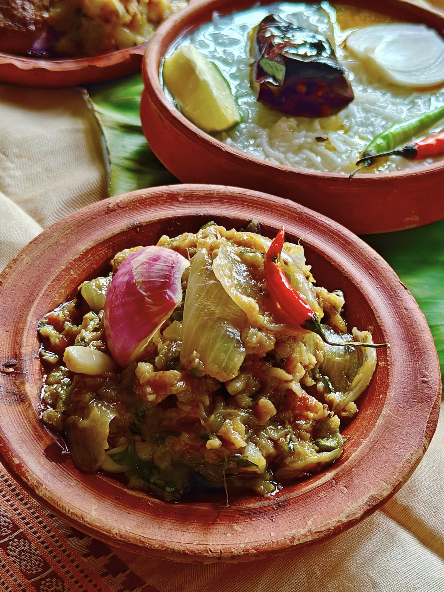 Smoky mashed brinjal, fish, and potato bharta.