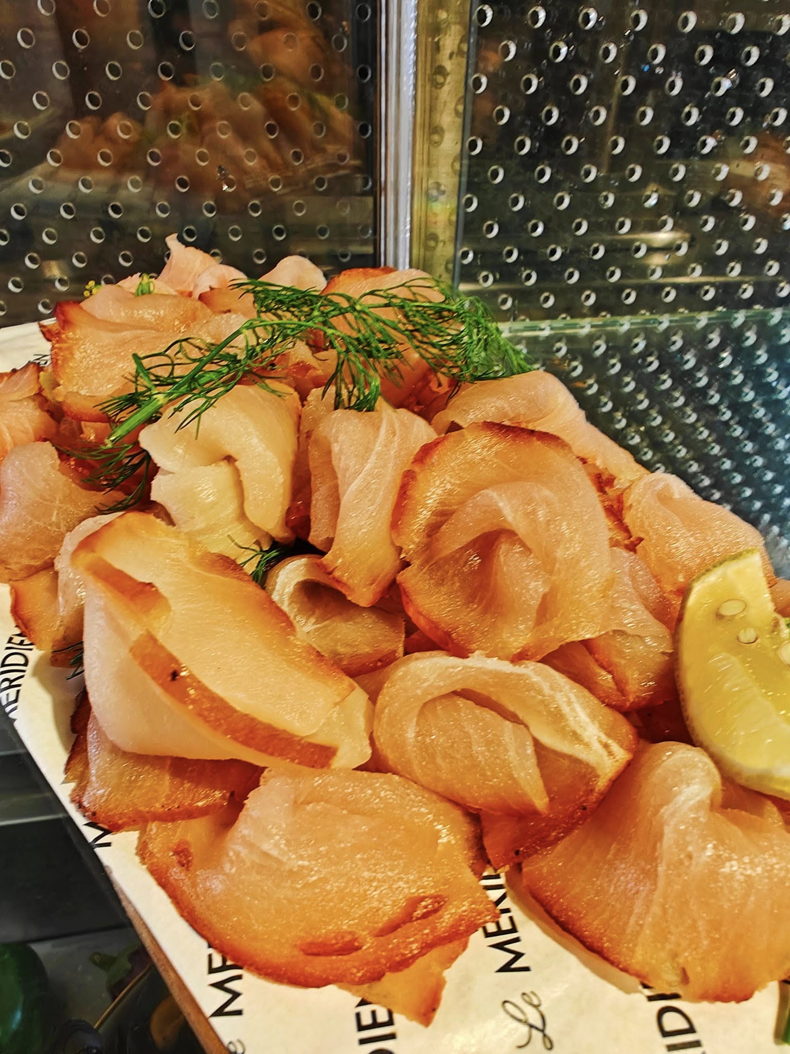 Cold smoked salmon delicately plated with fresh garnish