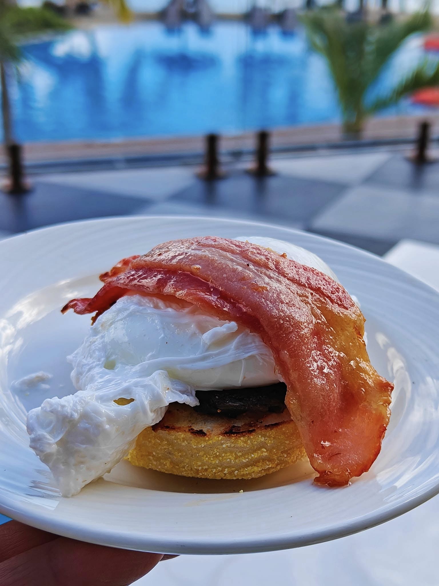 Eggs Benedict topped with creamy hollandaise sauce for breakfast