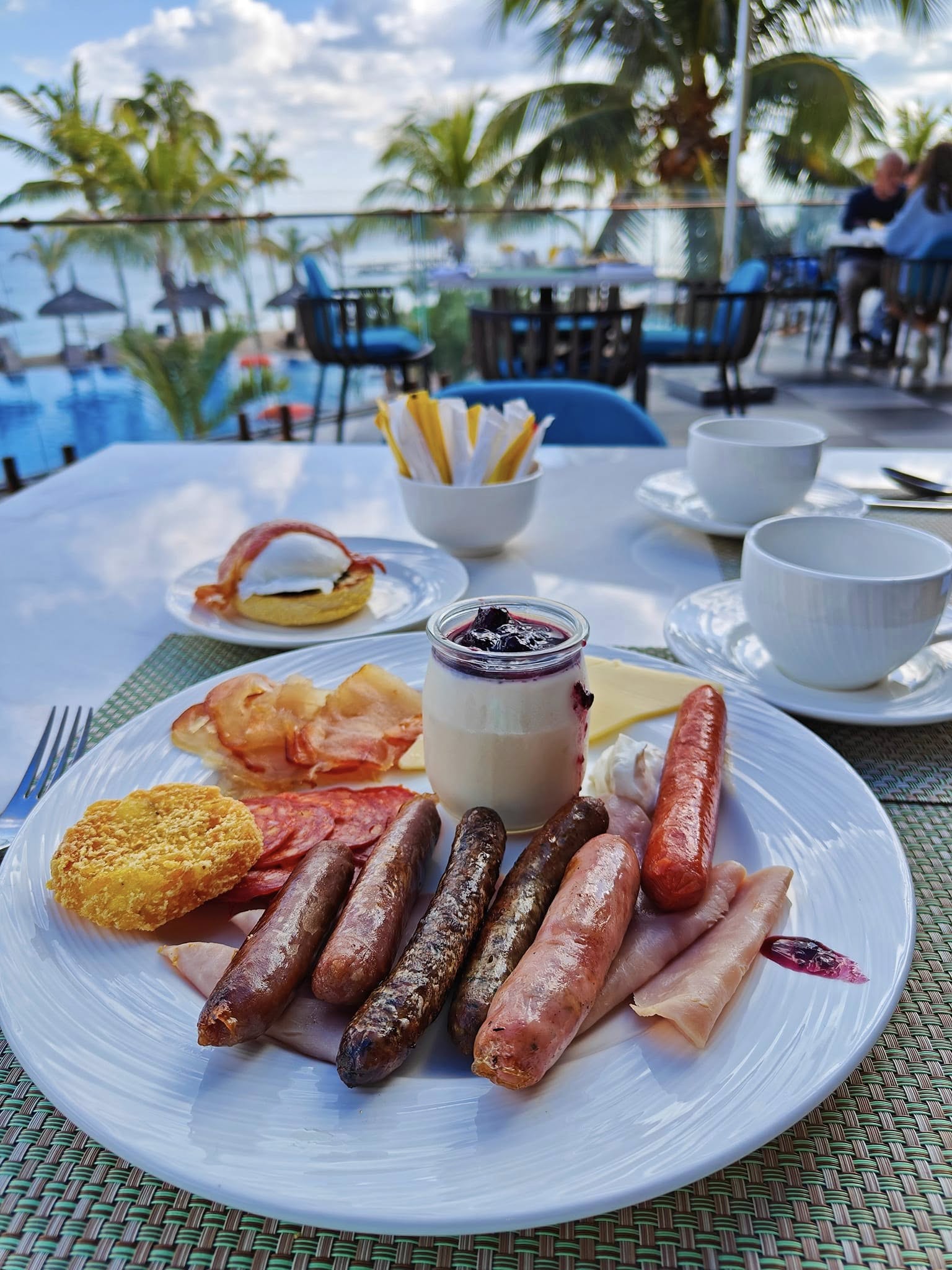 Classic English breakfast with eggs, sausages, beans, and toast