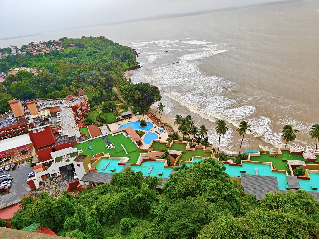 A charming street in North Goa with whitewashed Portuguese-style buildings and lush greenery