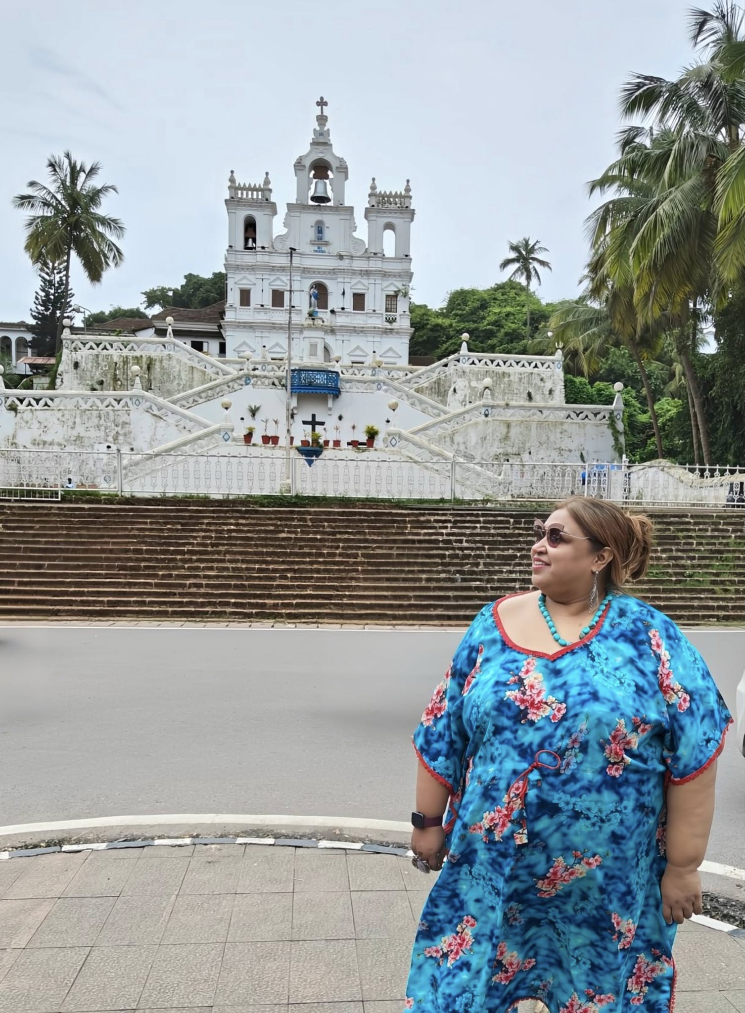 The iconic Our Lady of the Immaculate Conception Church in Goa, featuring its striking white faΓ§ade and grand zigzag staircase.