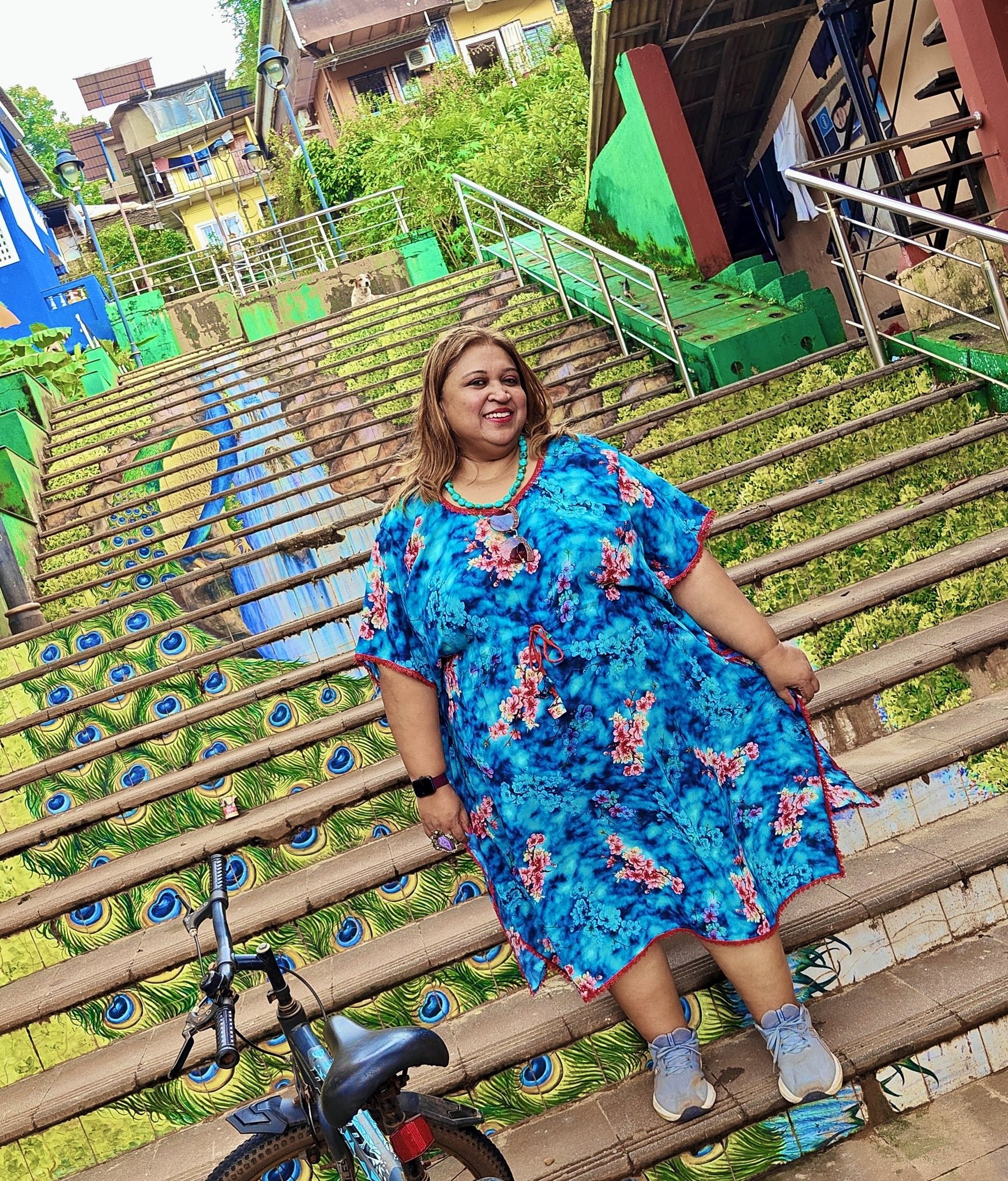 Colorful peacock mosaic staircase in North Goa, with vibrant blue, green, and gold tiles forming a large peacock design along the steps.