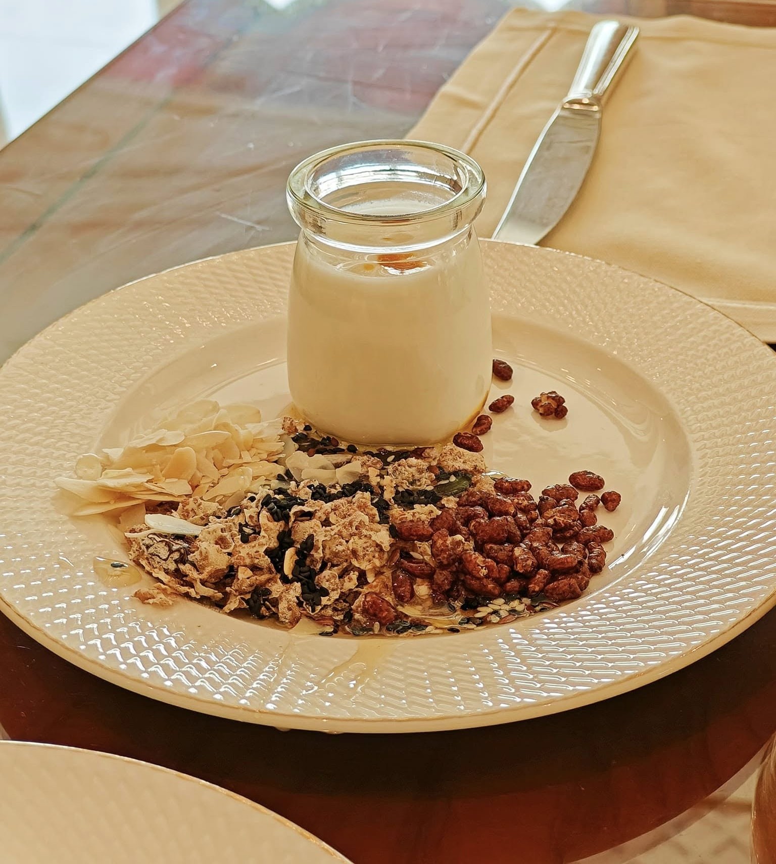 Breakfast cereals, nuts, and dried fruits displayed at a buffet at Raffles The Palm, Dubai