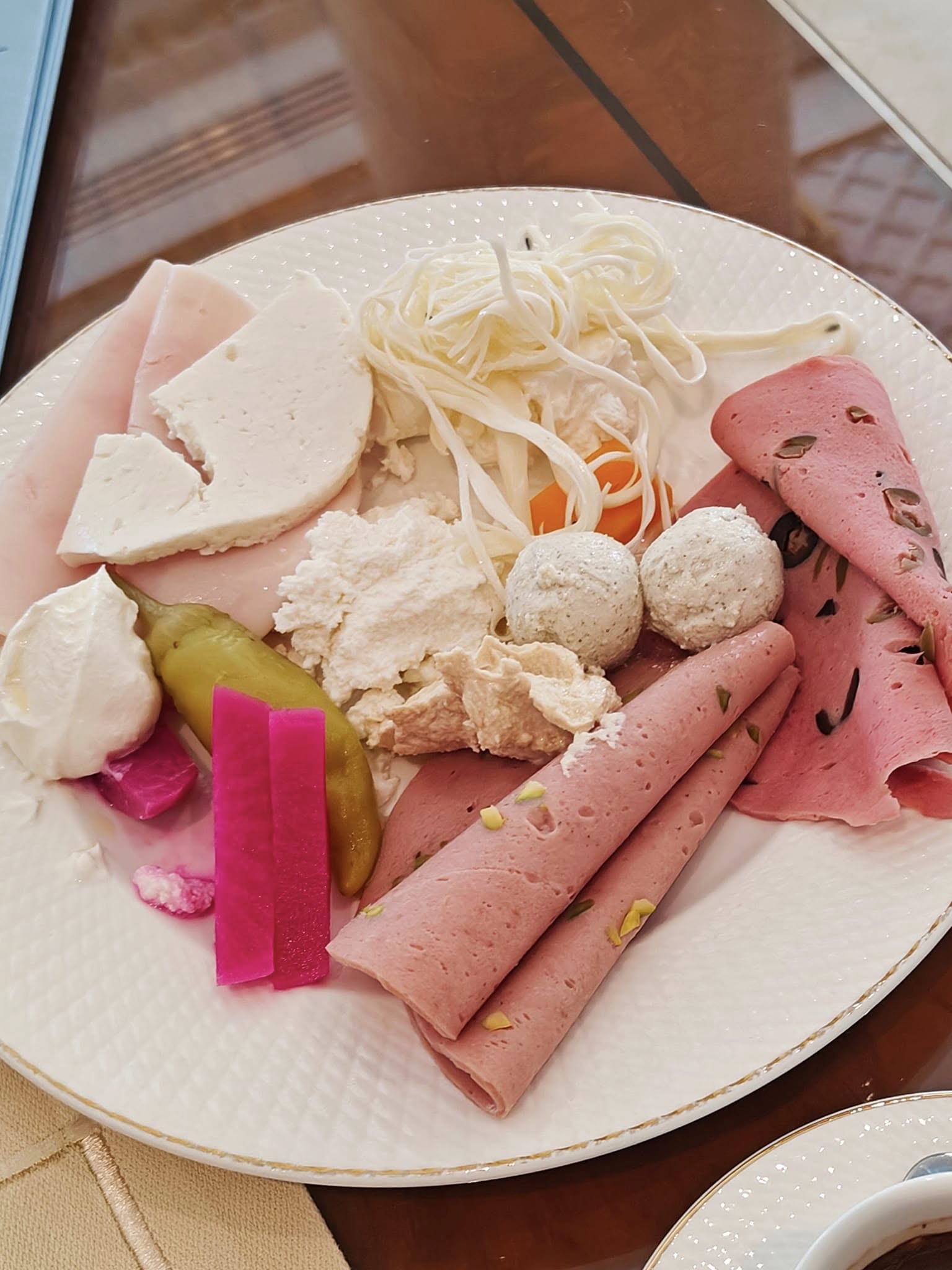 Traditional Emirati breakfast spread with local cheeses, bread, and accompaniments served at Raffles The Palm, Dubai.