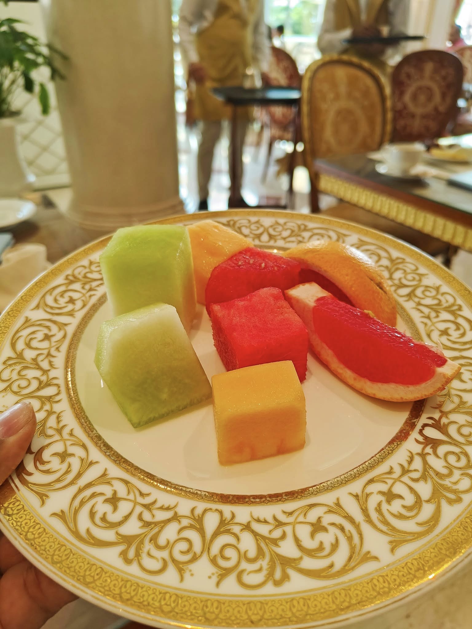Colorful assortment of fresh fruits including watermelon, pineapple, and berries at the breakfast buffet at Raffles The Palm, Dubai.