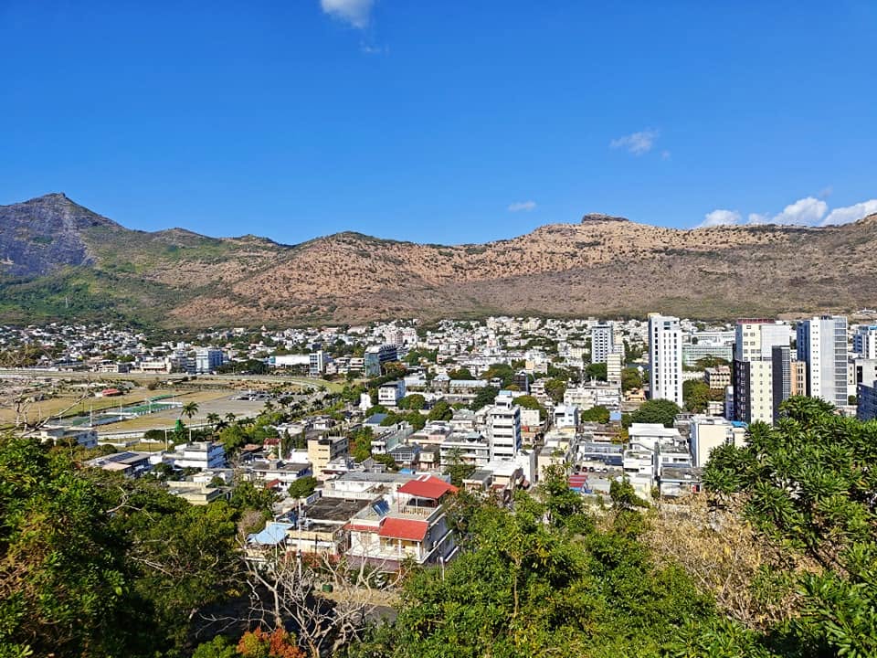Panoramic view from La Citadelle's observation deck in Moka, Mauritius, with the Moka mountain range stretching into the distance under a clear blue sky.