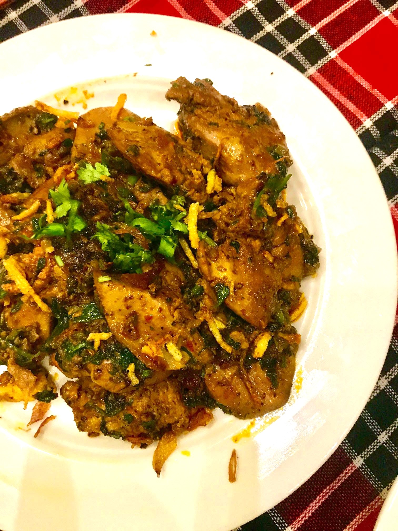 Parsi-style chicken kaleji (chicken liver) cooked with spices and garnished with fresh coriander.