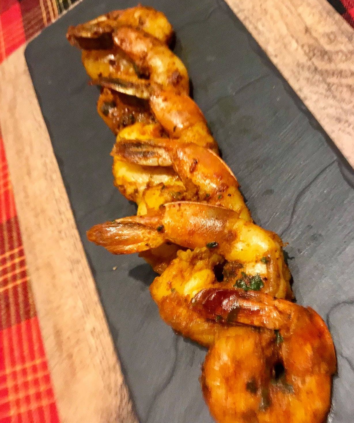 Parsi Tatrela Prawns – spicy stir-fried prawns coated in a rich, tangy masala.